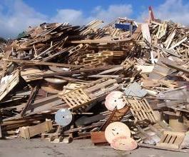 a huge pile of wooden waste such as wooden boards, wooden pallets