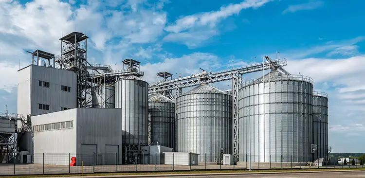 Exterior view of a feed plant with large silos