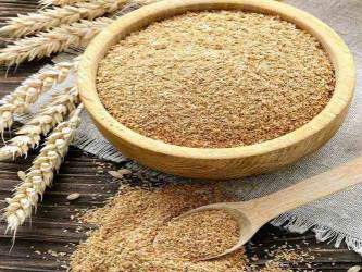 wooden bowl filled with wheat bran